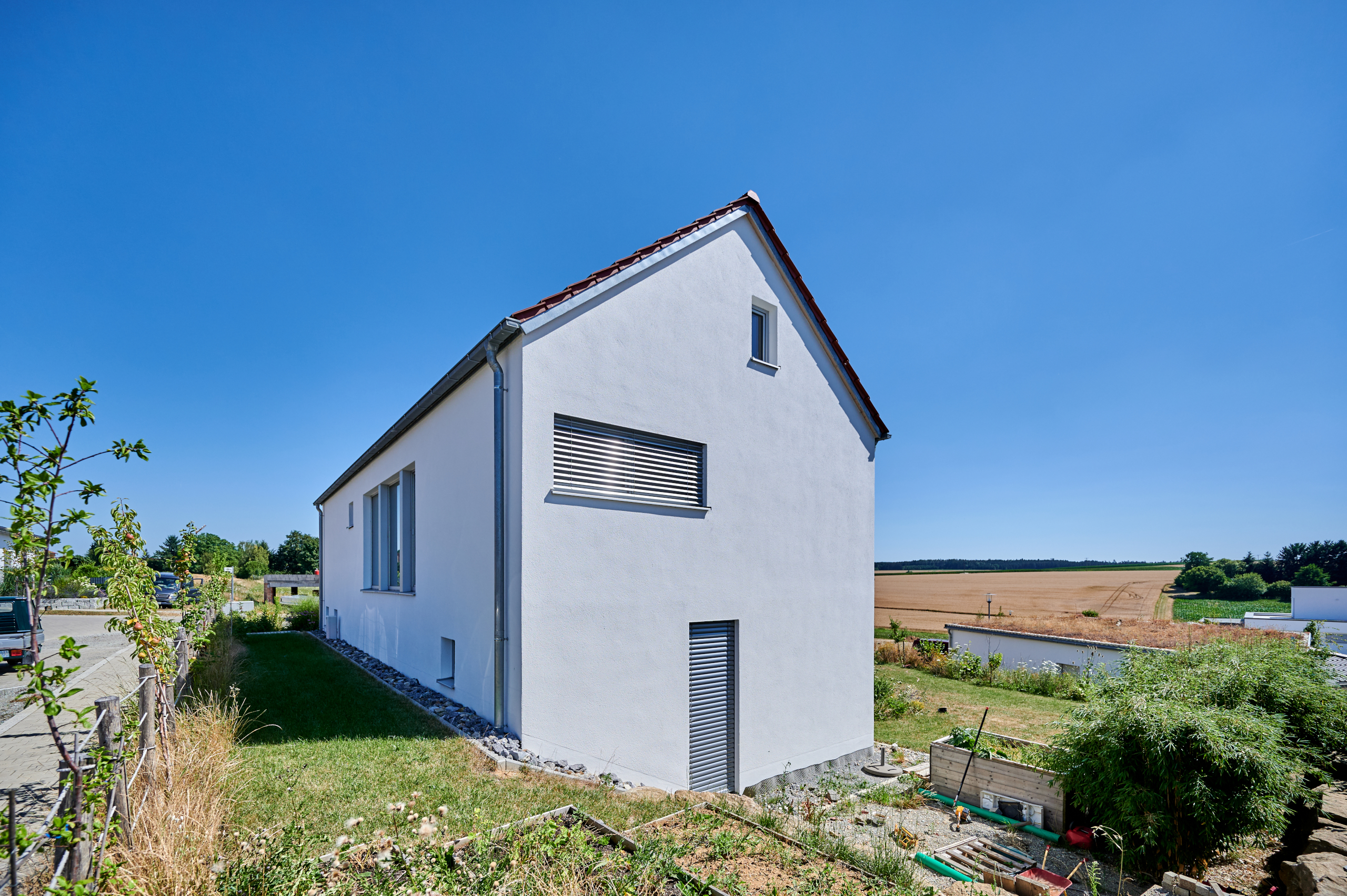 Giebelseite Massivholzhaus We_S mit Putzfassade